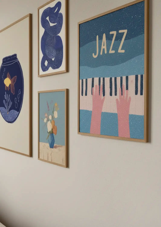 Gallery wall with playful blue and pastel posters, including a jazz piano illustration, hanging on a light wall in a Scandinavian home.