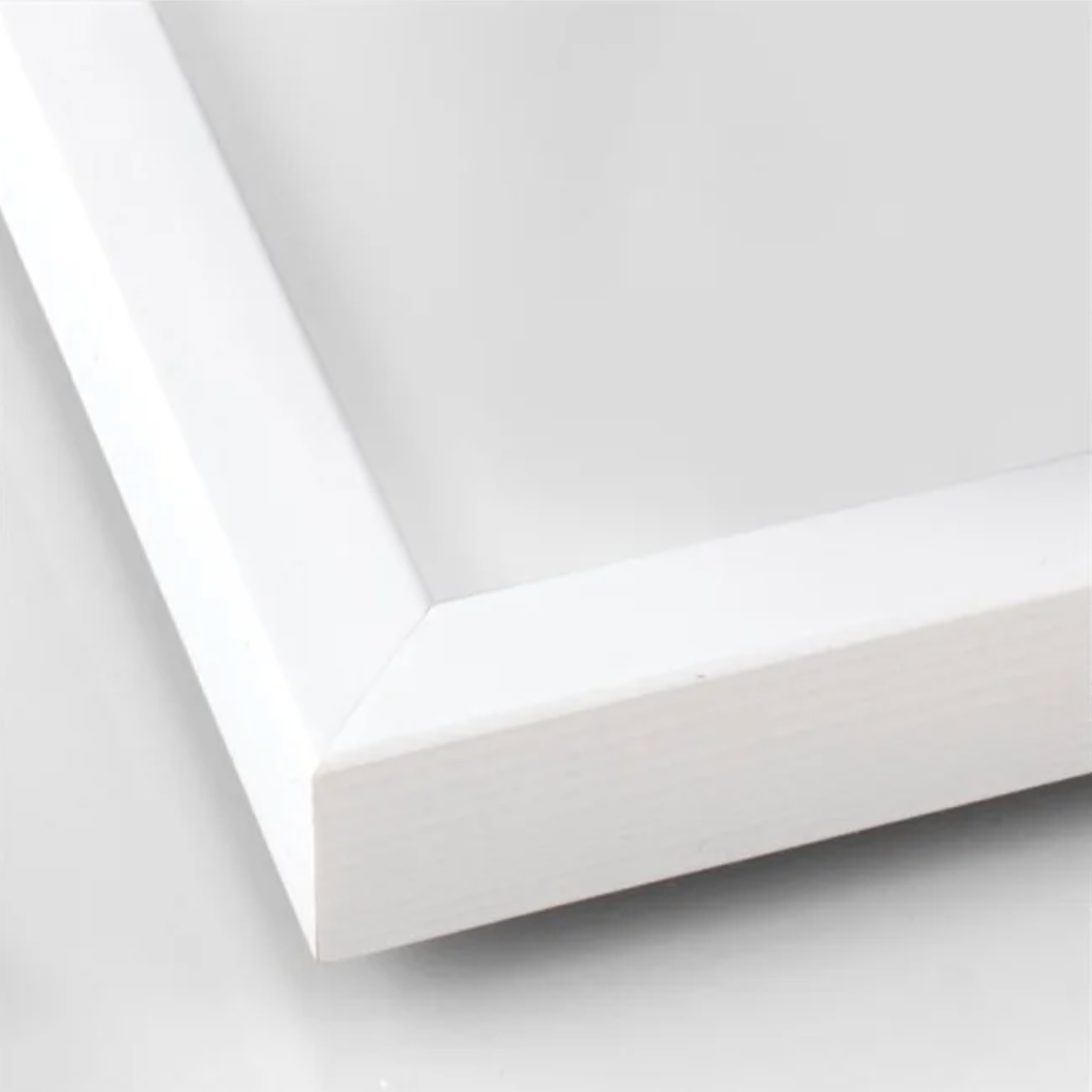 Close-up of smooth white wood texture and corner join on picture frame