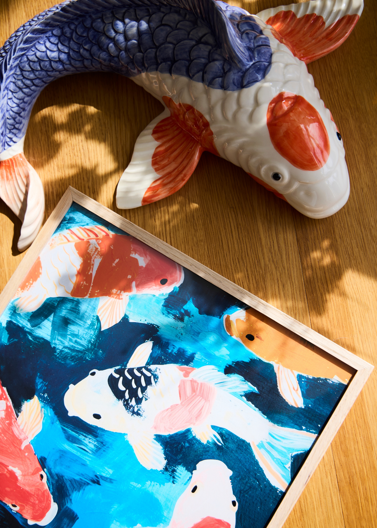 Koi plakat fra HelloPoster – farvestrålende fisk i røde og blå nuancer på livlig blå baggrund