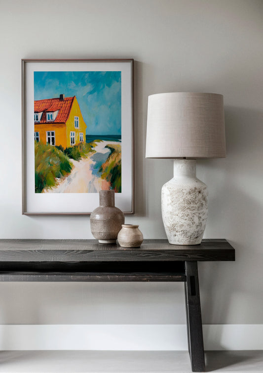 My Summer House poster in a modern Scandinavian living room with dark wood console and neutral decor, featuring a colorful yellow beach house with blue sky and coastal landscape tones.