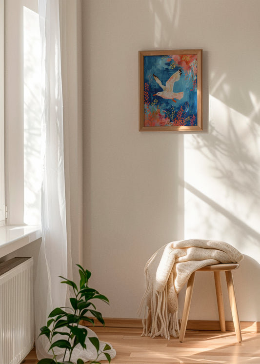 Seagull - HelloPoster - Poster of a white seagull in a colorful underwater-inspired scene hanging on a beige wall in a sunlit room with a wooden stool, cream blanket, and a green plant by the window.