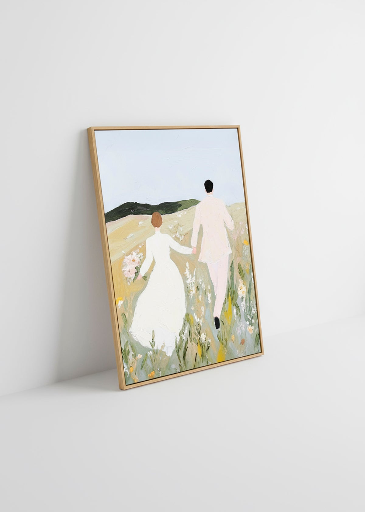 “Us” framed canvas resting against a white wall in bright daylight.