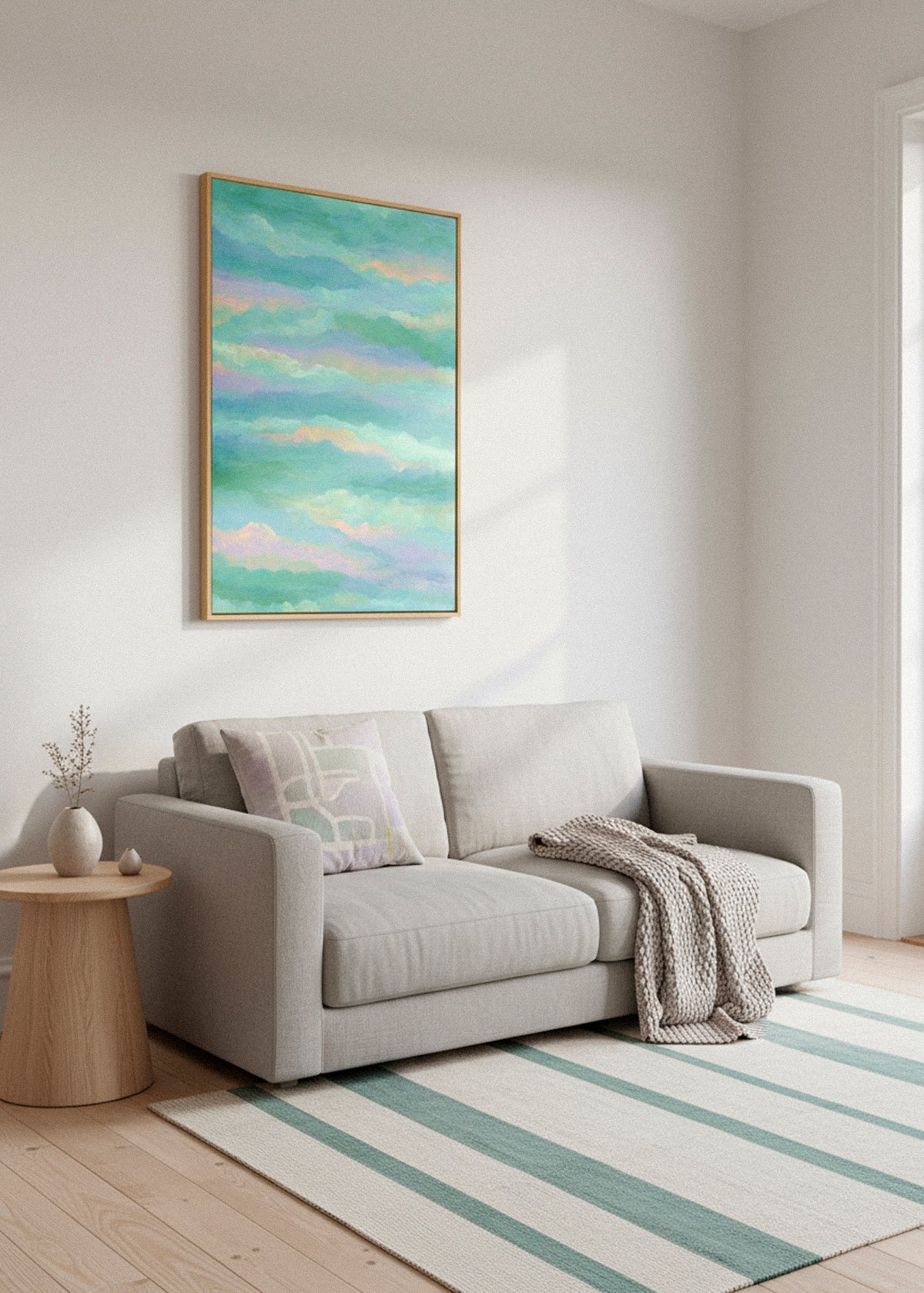 Canvas artwork titled “Behind the Cloud” hanging above a light grey sofa, with soft natural light creating shadows on a white wall.