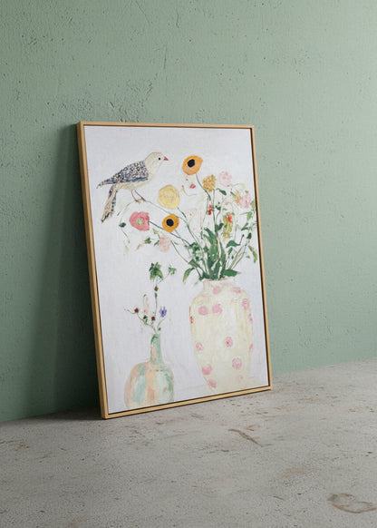Bird No. 1 canvas print leaning against a green textured wall, showcasing a delicate bird perched above pastel flowers in soft, airy colours. Hello Poster wall art.