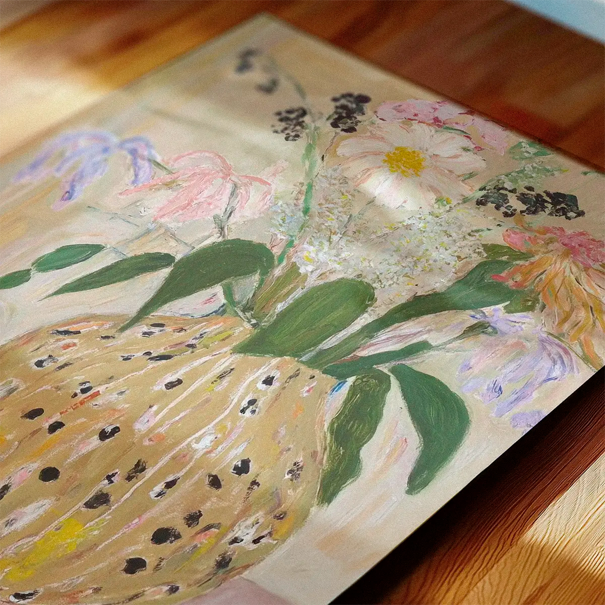 Botanical bird art print ‘Bird No. 2’ lying on a wooden table in warm daylight with soft shadows and natural textures.