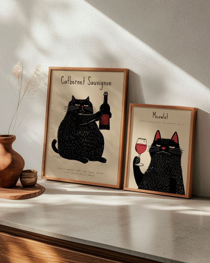 Two playful cat posters titled "Catbernet Sauvignon" and "Meowlot" displayed together in oak frames, adding humor and charm to a kitchen or dining space.