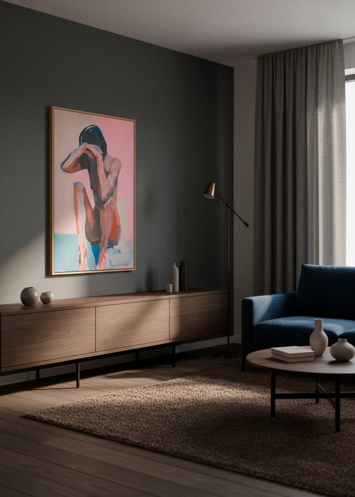 Framed croquis-style canvas artwork of a seated figure in pink and blue tones hanging on a dark grey wall above a wooden sideboard.