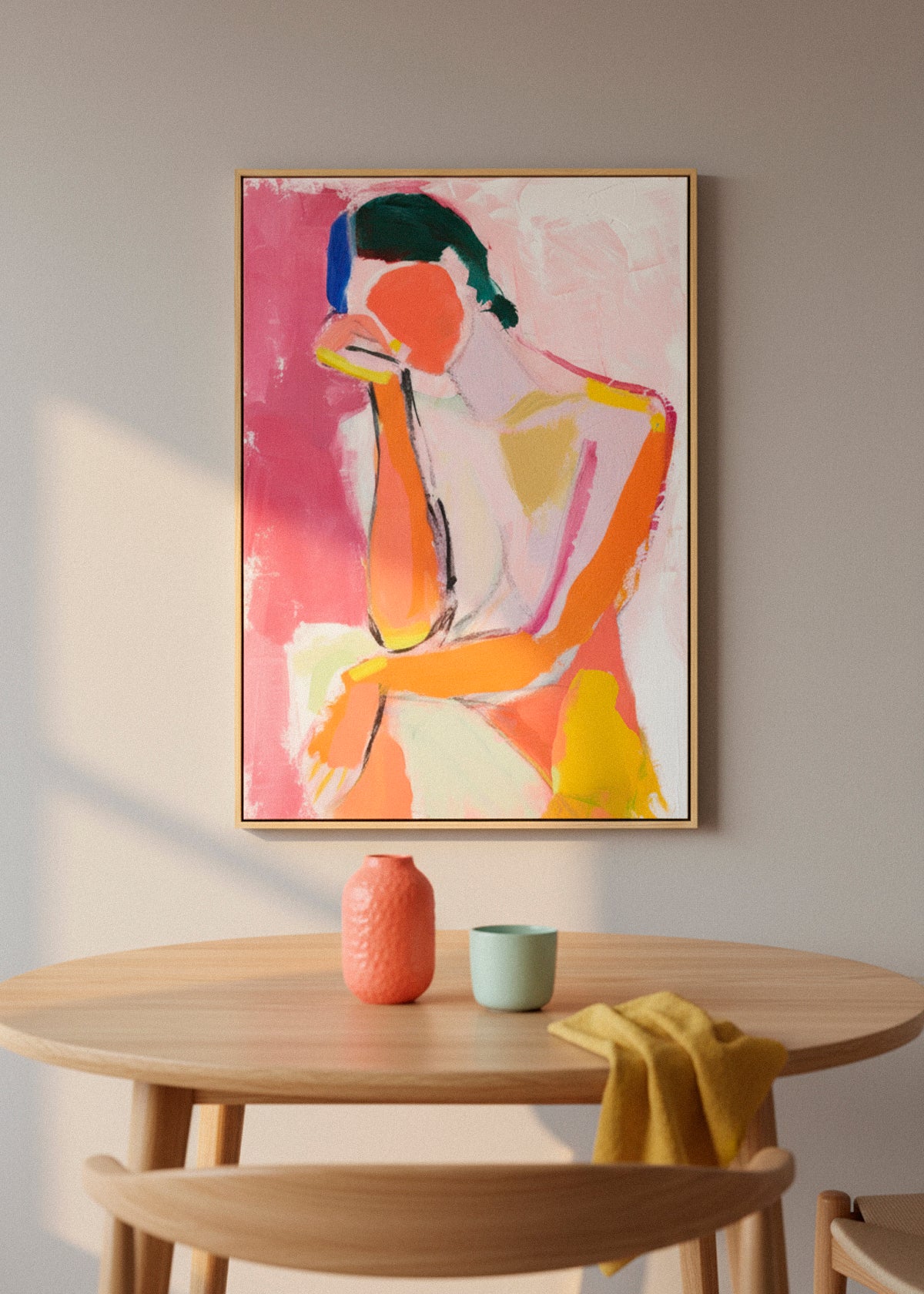 Feminine canvas hanging on a white wall above a dining table. Elegant soft-toned portrait creating a warm and inviting dining space.