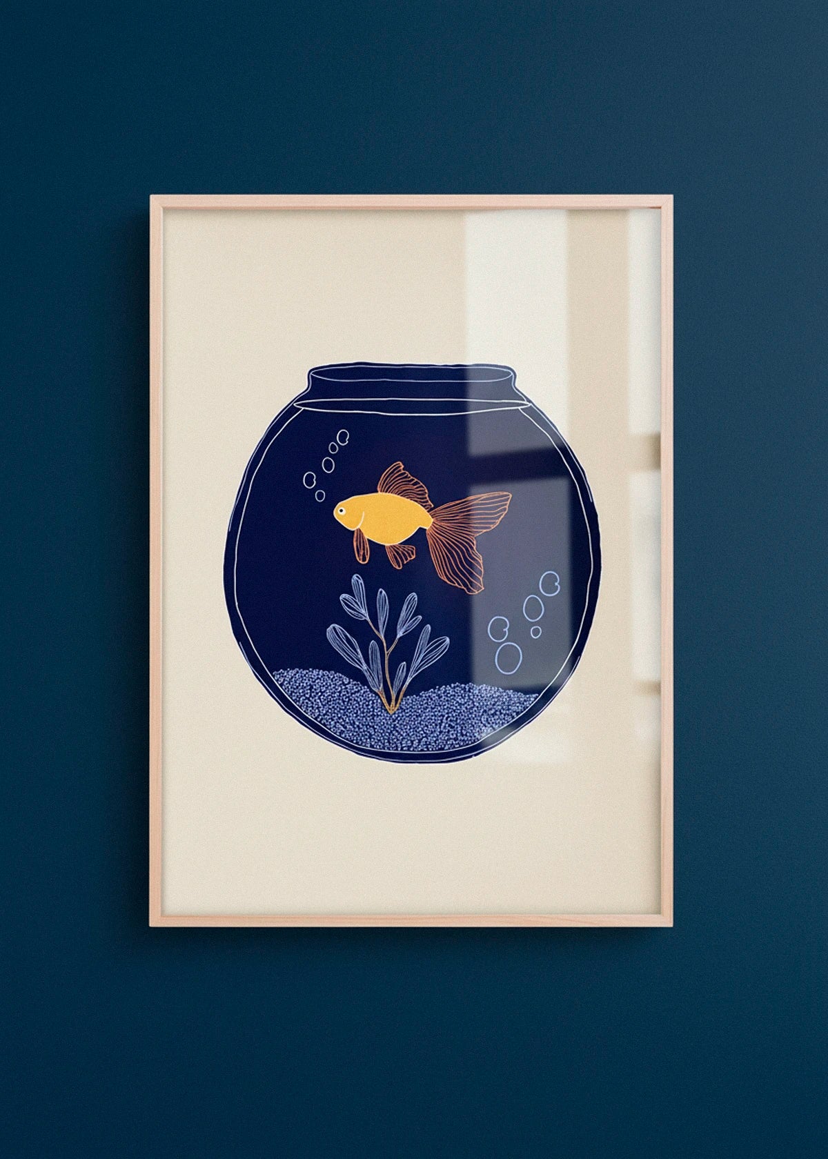 The Fishy poster with a yellow fish in a navy bowl, hanging on a beige wall with warm afternoon sunlight.