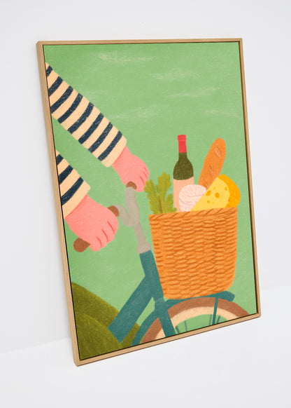 French Picnic canvas print – illustration of bicycle with striped sleeves and picnic basket containing bread, cheese, wine, and greens