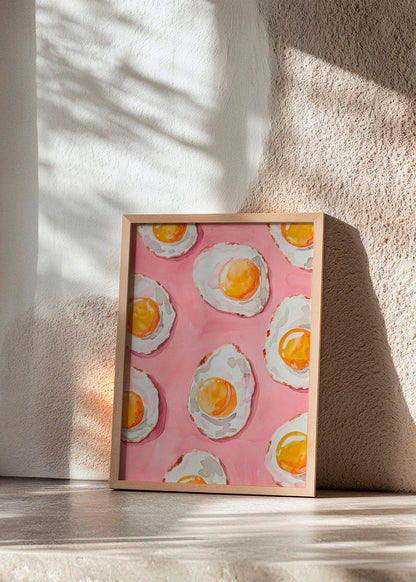 Whimsical kitchen poster titled "Fried" featuring sunny-side-up eggs on a vivid pink background, ideal for adding color and fun to your home decor.