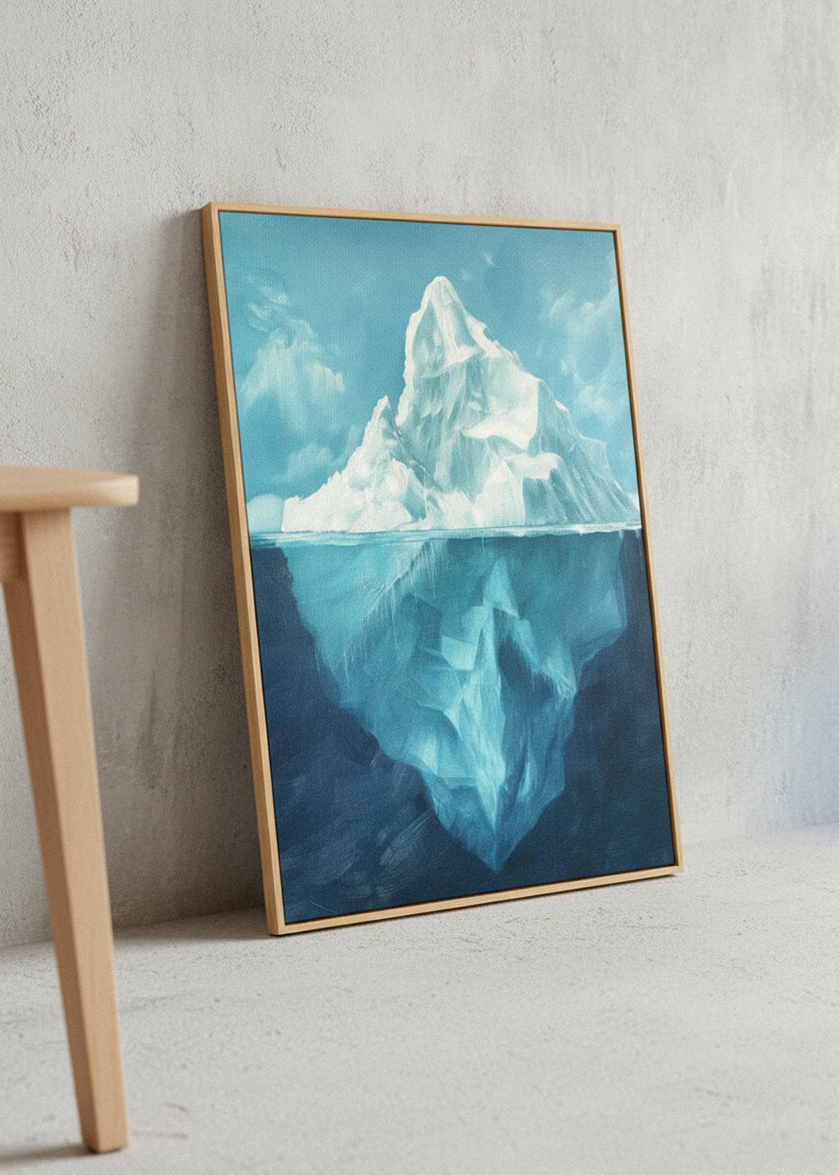 Iceberg Day canvas print by HelloPoster leaning against a light grey wall, showing a bright blue iceberg above and below the waterline in soft natural daylight.