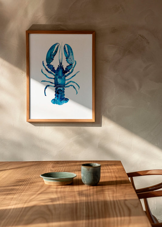 Indigo Lobster art print by Hello Poster in a wooden frame, styled in a warm Scandinavian dining space with natural light and wooden table setting.