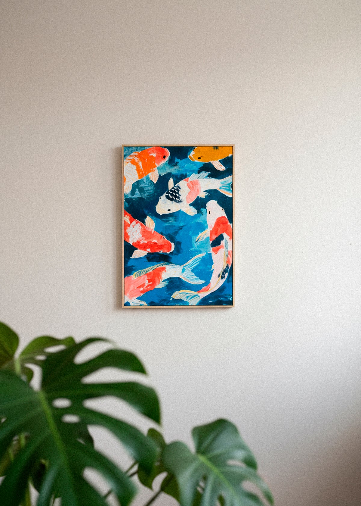 Koi fish canvas leaning against a beige wall with soft curtains and natural light.
