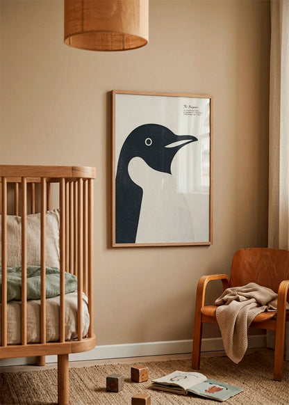 Minimalist Penguin Profile by Ohkimiko displayed on the wall in a warm nursery interior with wooden furniture and soft neutral tones.