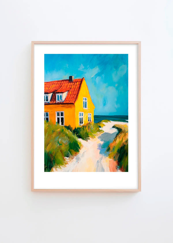 My Summer House poster in a minimalist Scandinavian interior with light grey wall and natural wood frame, featuring a bright yellow coastal house, sandy path and deep blue ocean tones.