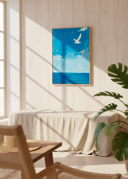 Framed “Ocean” canvas print hanging on a light wall above a wooden table, capturing calm coastal energy and airy simplicity.