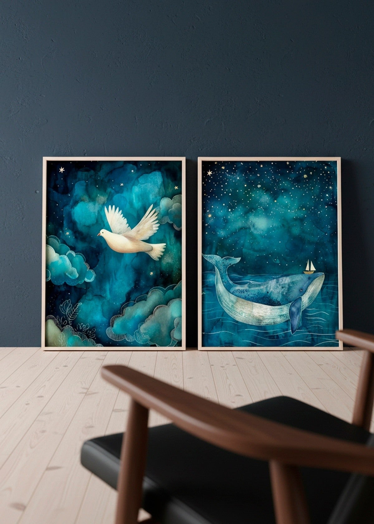 Two framed posters — One Big Friend with a dreamy blue whale under a starry sky and One Small Friend with a white dove flying through soft teal clouds — styled against a deep blue wall in a Nordic interior.