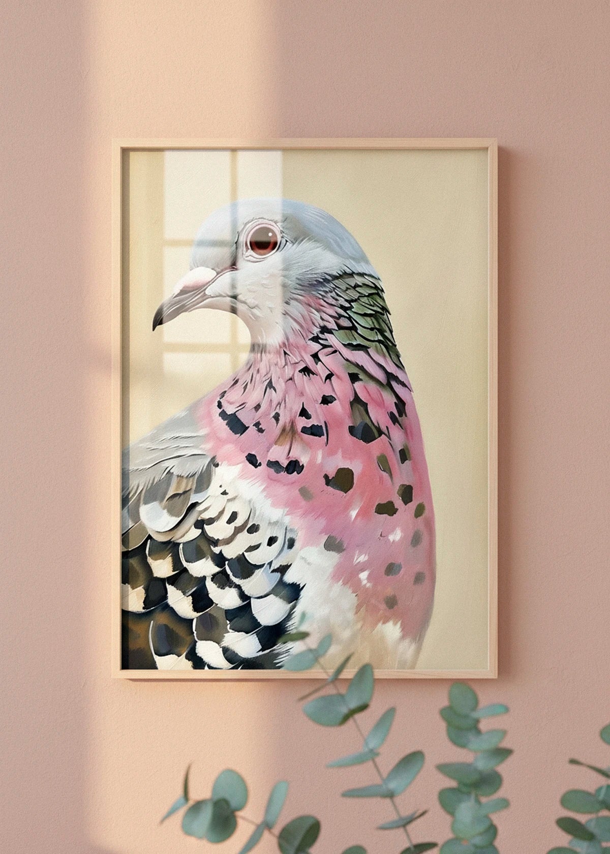 The Pigeon poster displayed on a warm-toned wall with sunlight and eucalyptus branches in the foreground.