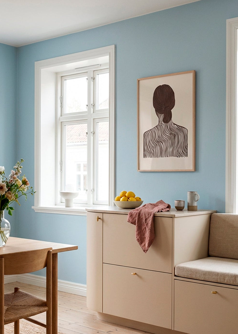 Minimalist line art poster “Quietly Yours” displayed in a Scandinavian dining room with blue walls, light wood furniture and soft natural light.