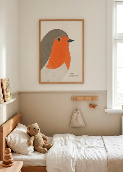 Red Robin New Beginnings art poster by Ohkimiko displayed in a calm children’s bedroom with natural wood furniture, soft beige tones, white bedding and warm daylight.