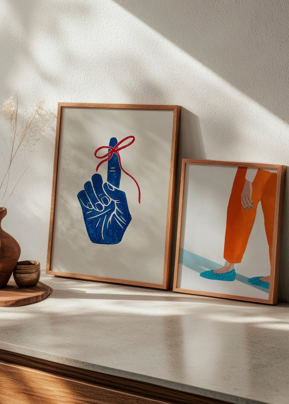 Pairing of the thoughtful 'Moody Nails' artwork with the symbolic 'Remember' print in a cozy interior scene.