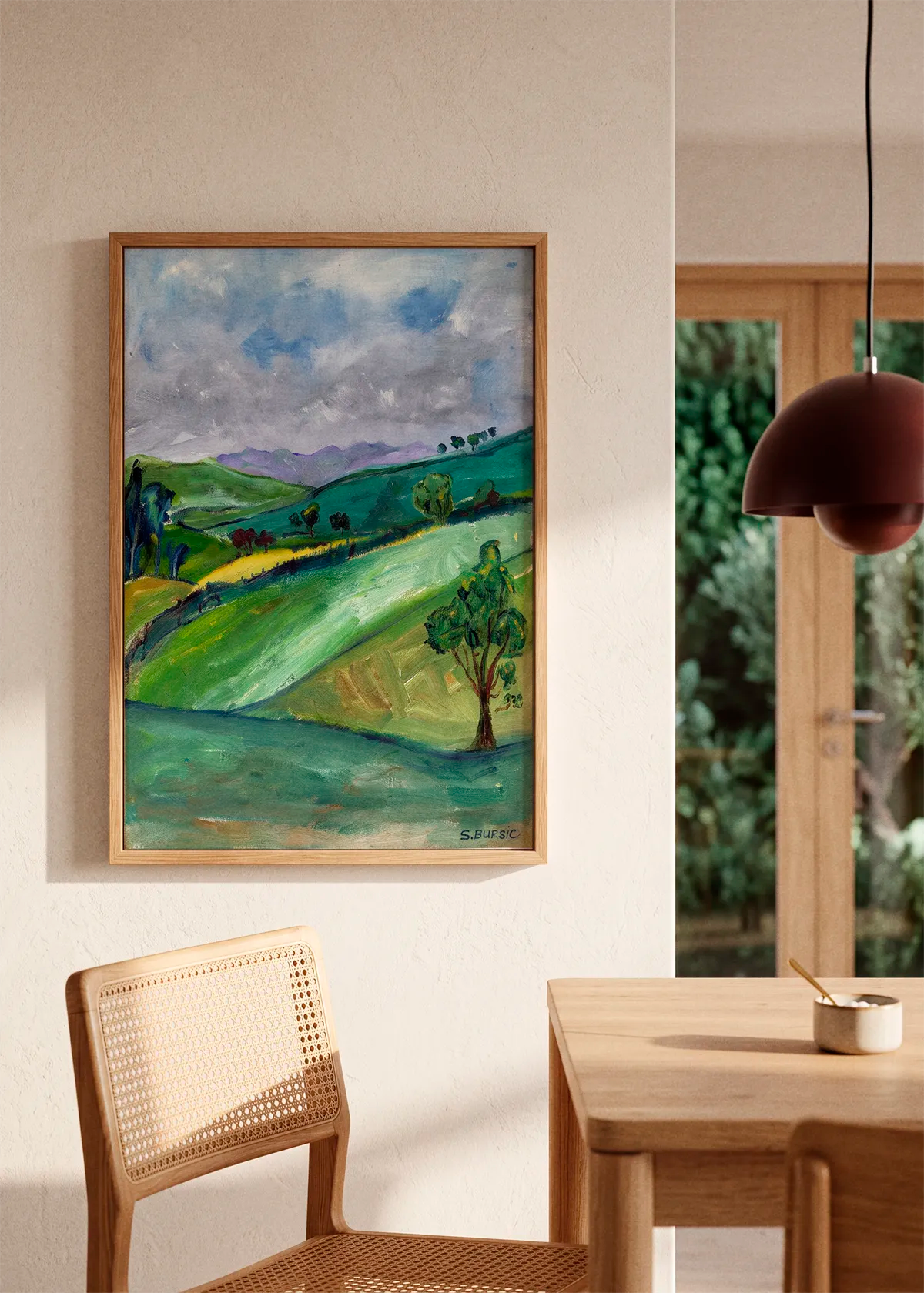 Rolling Green Hills by Sharyn Bursic featuring a painterly green countryside with rolling hills, scattered trees and a cloudy blue-grey sky.