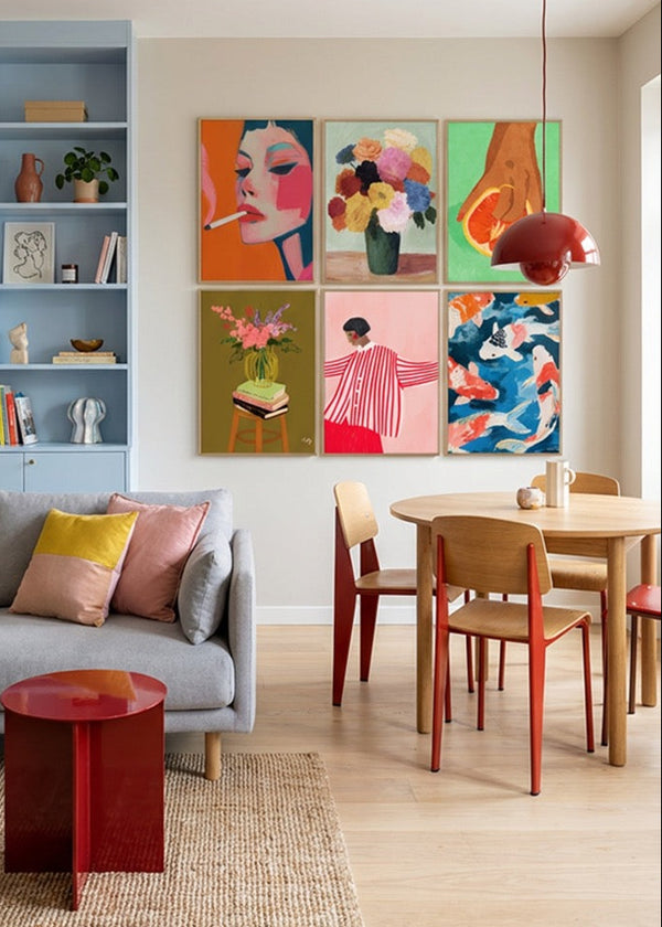 Colorful Hello Poster gallery wall featuring Smoke, Blossoms, Fruit Lover, Floral Vase, Red Stripes and Koi posters styled in a bright Scandinavian living and dining room with soft blue shelving, oak table and modern decor.