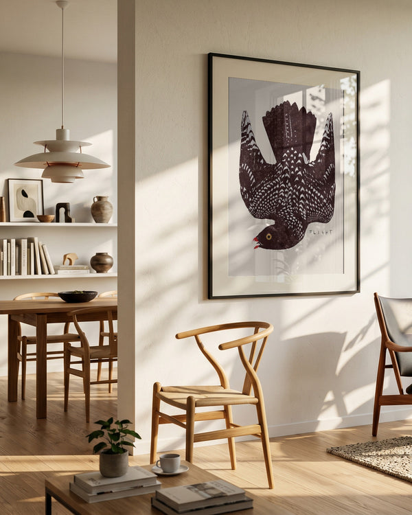 Speckled Bird Flight poster in a modern Scandinavian dining room with warm beige, black, white and natural wood tones, styled in a minimalist interior with soft sunlight and clean Nordic details.
