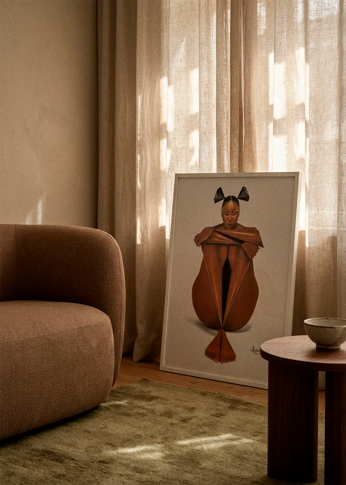 Thoughtful Folded Woman by Manasseh Johnson Sr. art print featuring a seated woman in a sculptural folded pose with geometric black hair details, displayed in a white frame beside a brown armchair in a warm Scandinavian living room.