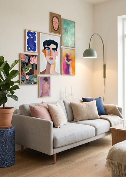 Gallery wall featuring Hello Poster designs including Junglemen, Chill, Shape No.10, Male, Hold Me, Midnight, Flower and Ballroom posters styled above a modern beige sofa in a bright Scandinavian living room with oak frames and soft neutral decor.