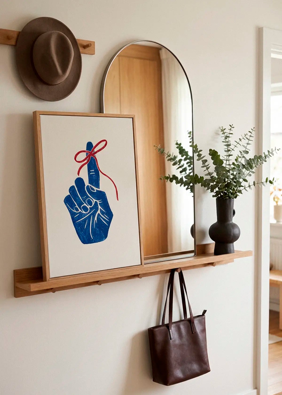 Remember poster styled in a Scandinavian entryway with mirror and wooden details