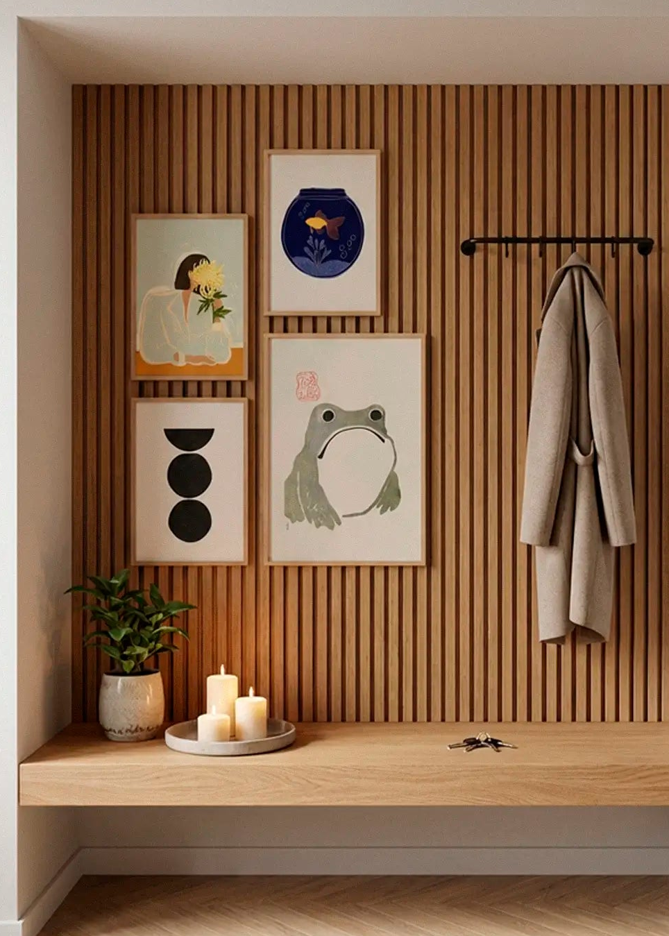 The Chrysanthemum, Fishy, Boulder and Grumpy Frog posters styled as a gallery wall in a Scandinavian entryway
