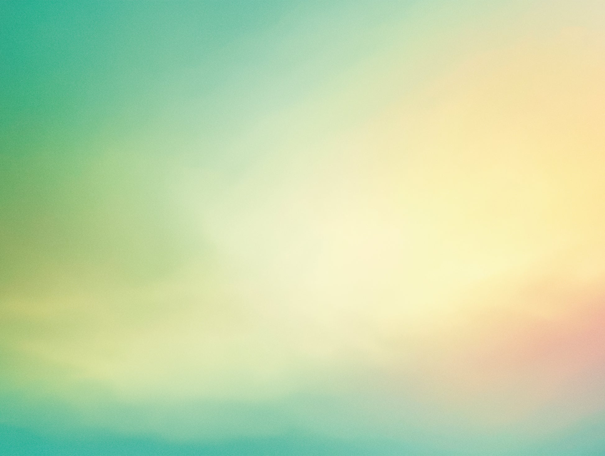 Close-up of a turquoise to yellow gradient design with soft color blending and pastel tones.
