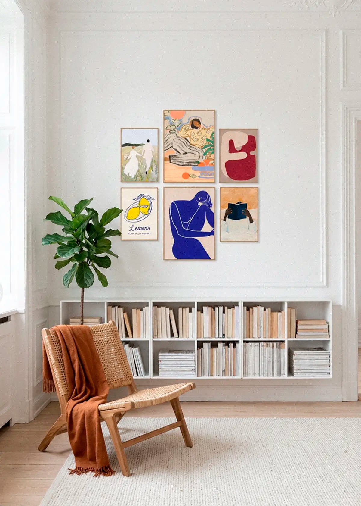 Us, Lazy Days, Lemons Paris Fruit Market, Red Geometric Shapes, Minimalist Blue Silhouette Figure and Must Read posters styled as a curated gallery wall in a Scandinavian living room